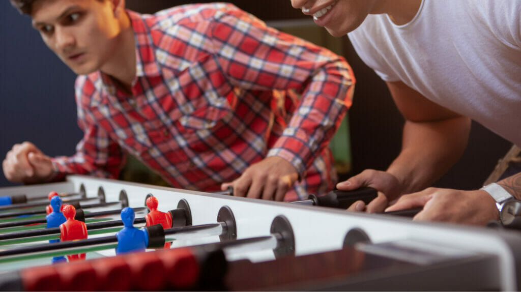 Two Men Playing Foosball