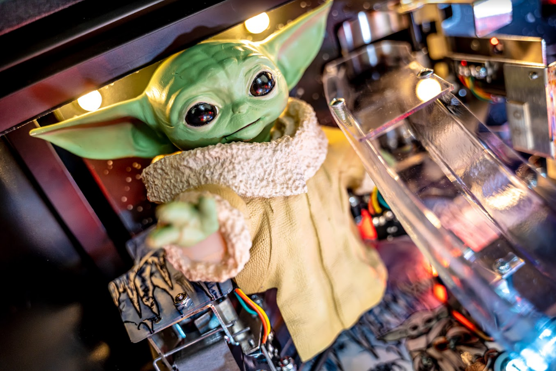 custom made grogu model from the mandalorian inside a pinball machine
